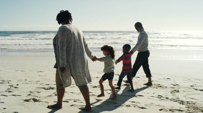 在沙滩上散步的一家人
