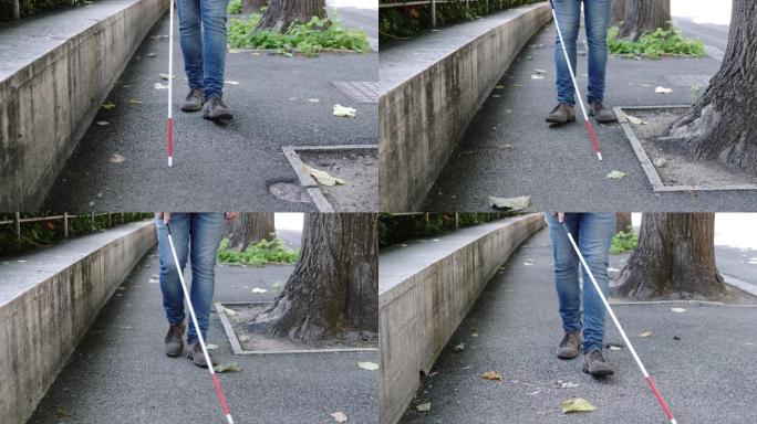 盲人拄着拐杖在街上行走