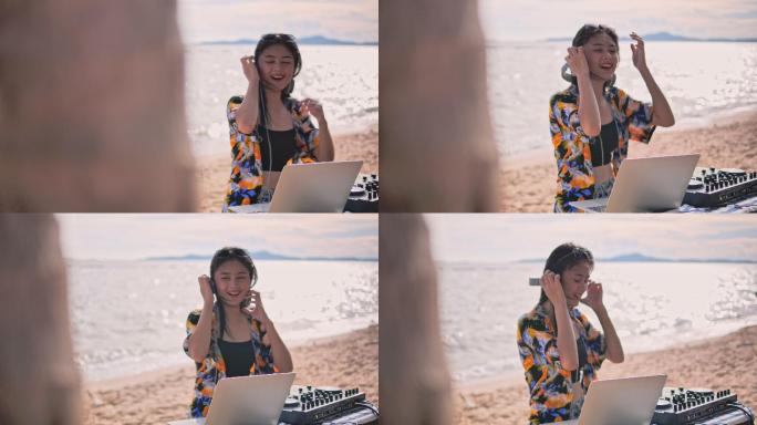 这位年轻女士在海滩上玩混合电子音乐