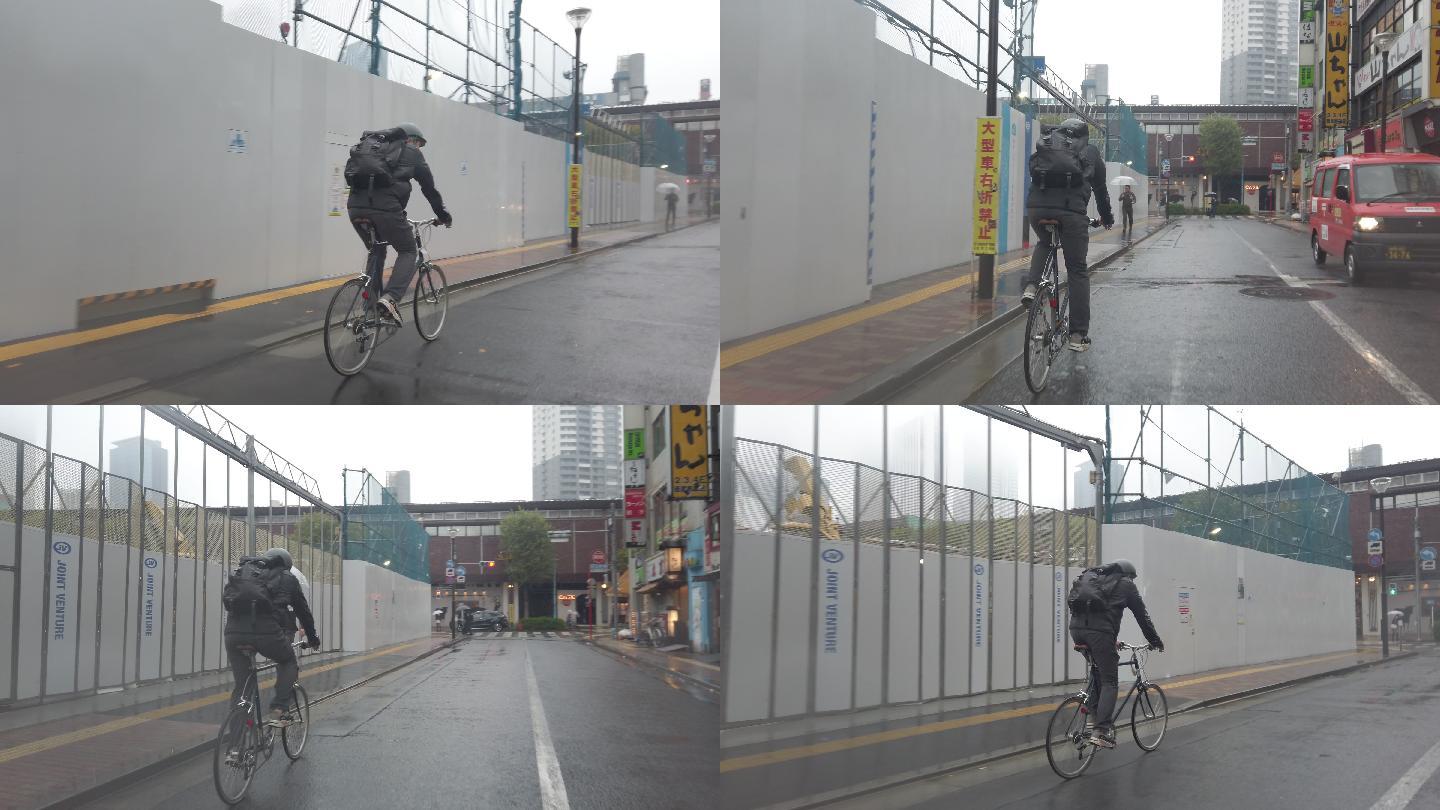 自行车信使在多雨的街道骑行