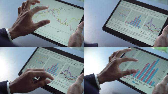 商人使用平板电脑和数字平板电脑进行股票市场数据业务
