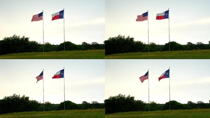 日落时，美国和得克萨斯州的旗帜在风中飘扬