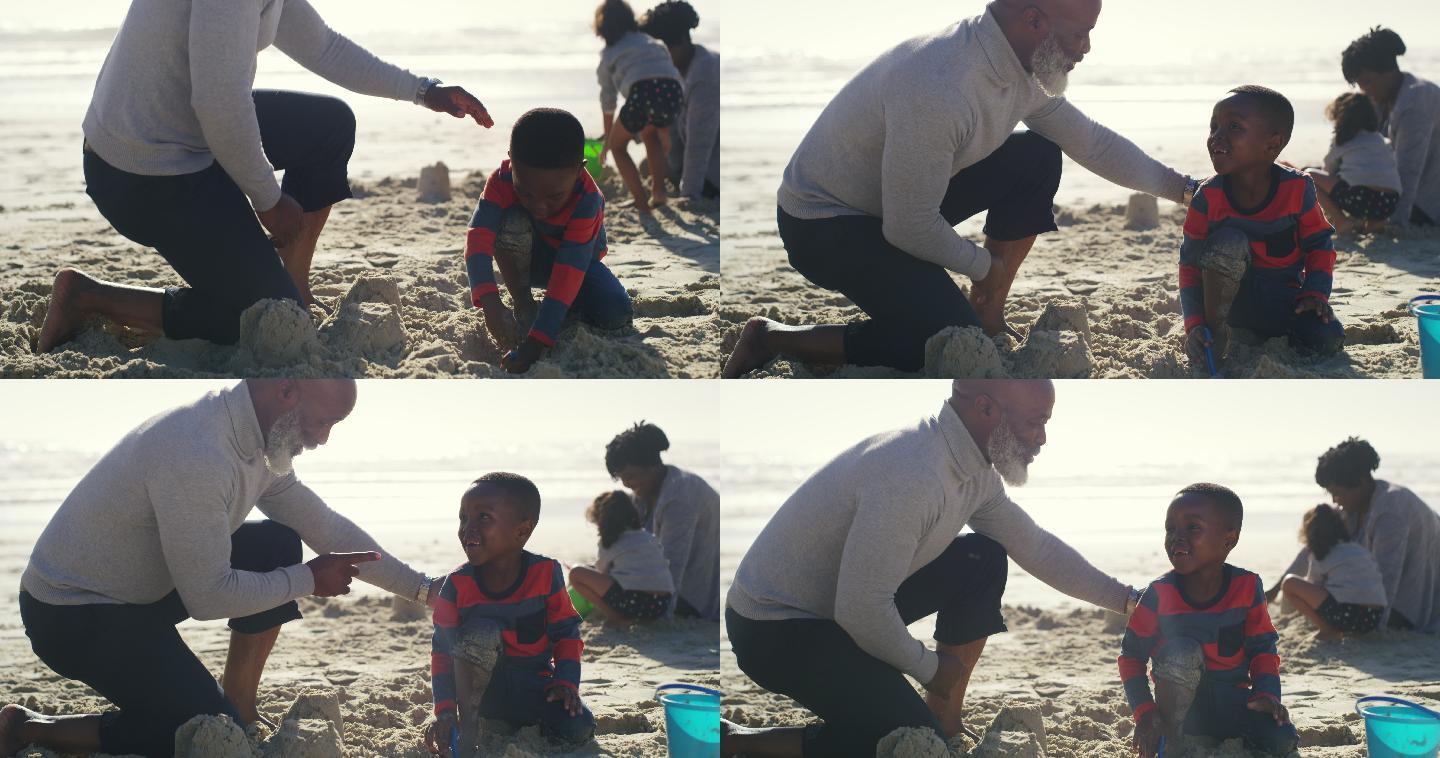 一个老人和他可爱的孙子在海滩上玩耍