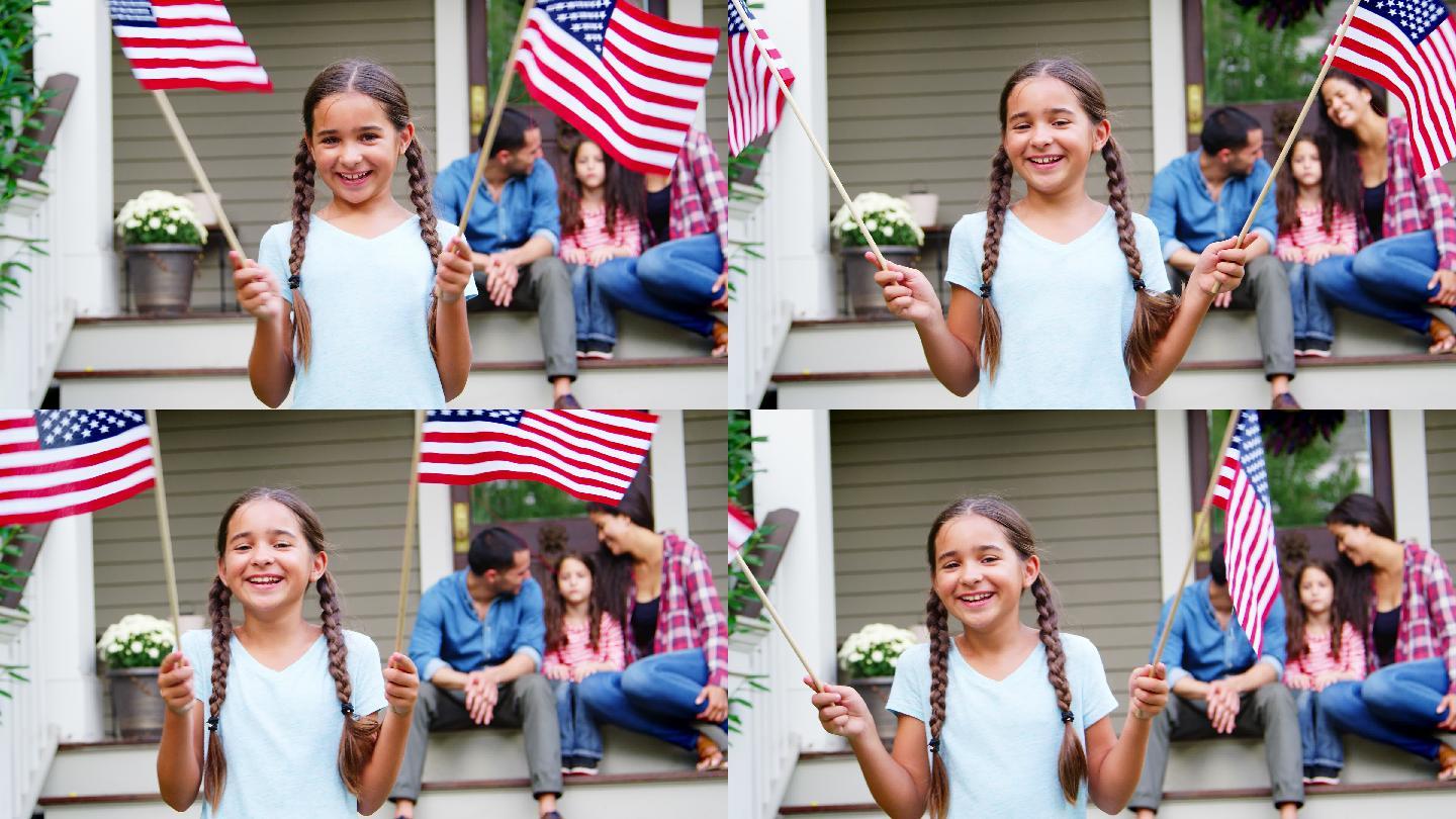 家门口举着美国国旗的女孩