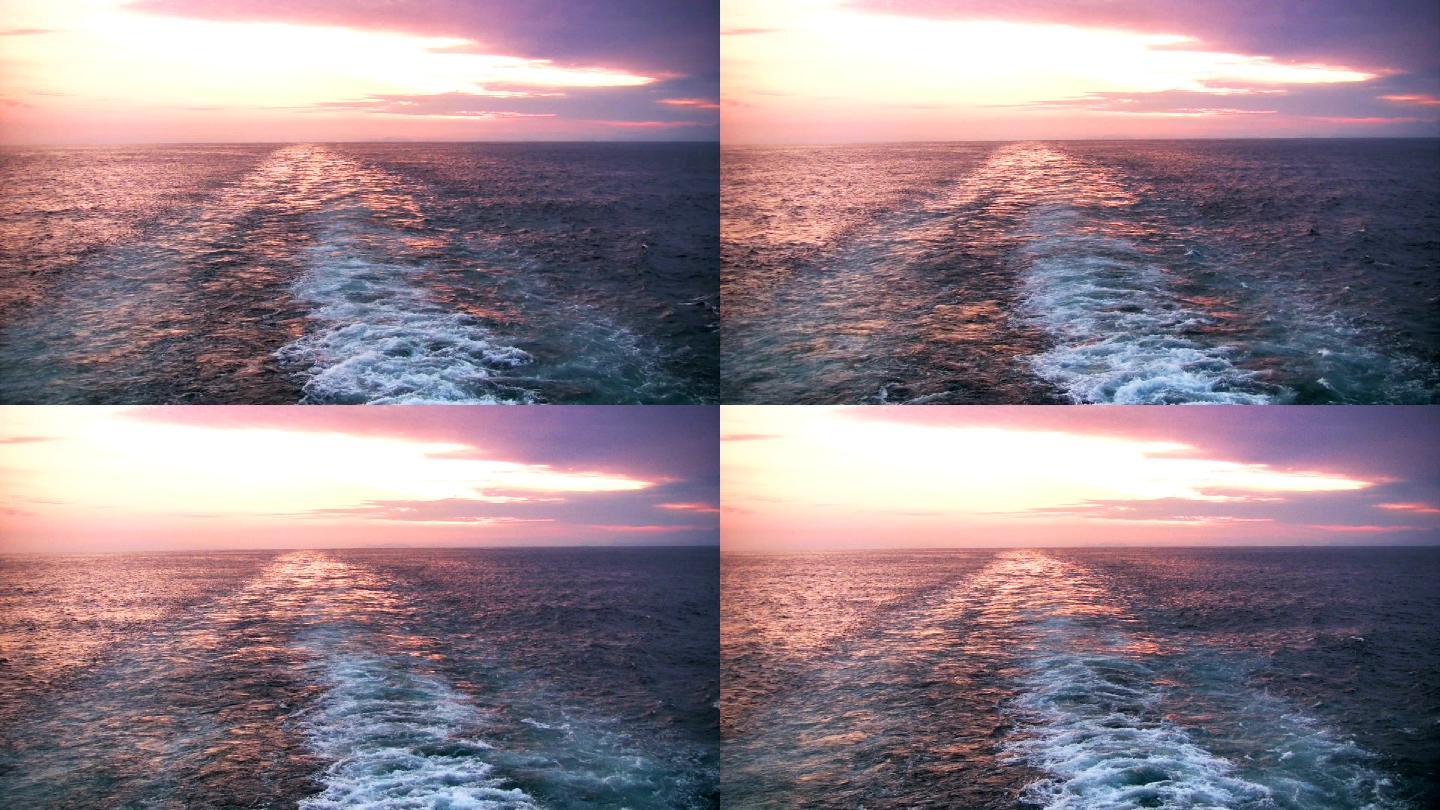 从一艘游轮的船尾观看五颜六色的日落
