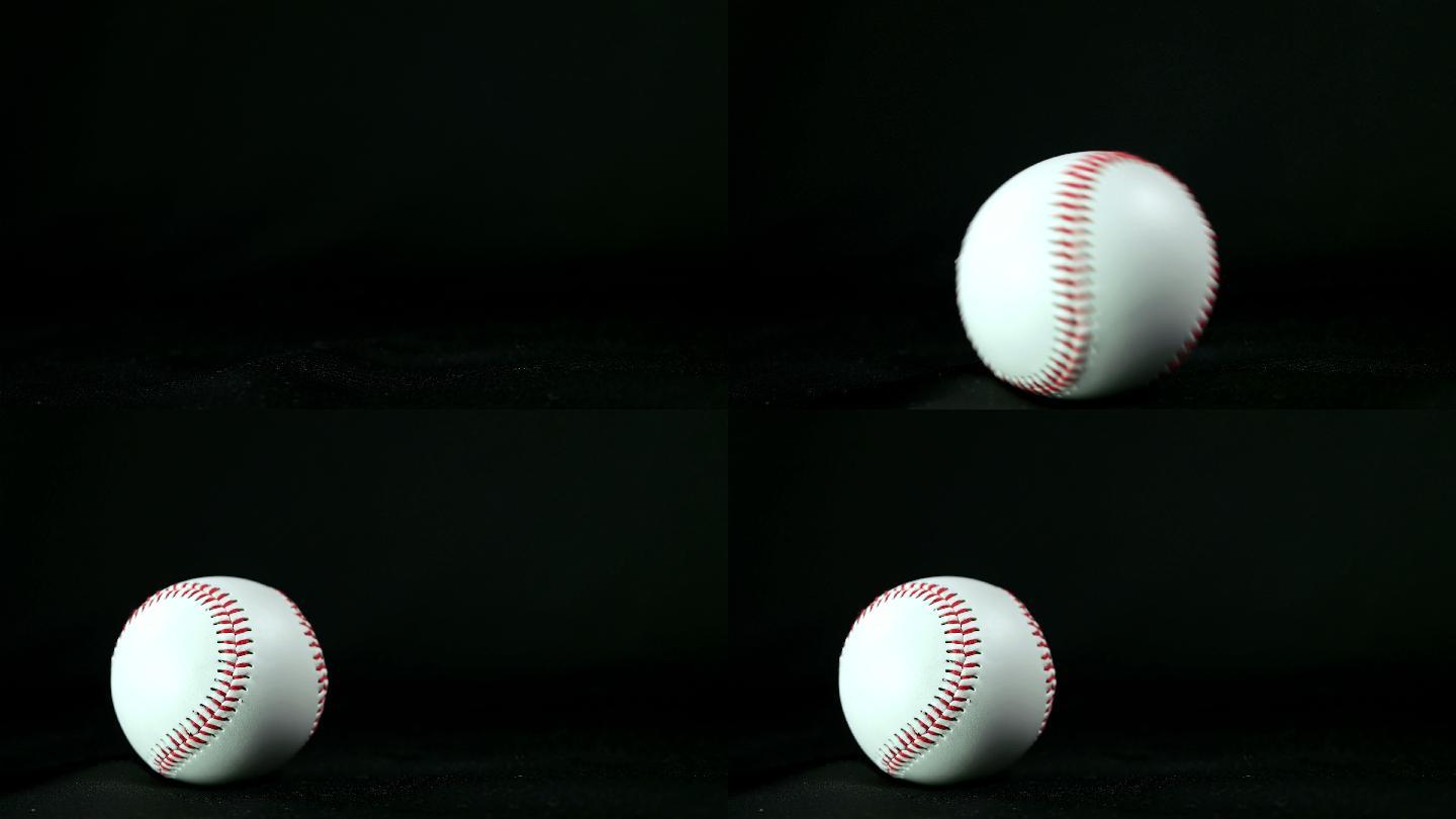 黑色背景上滚动的棒球