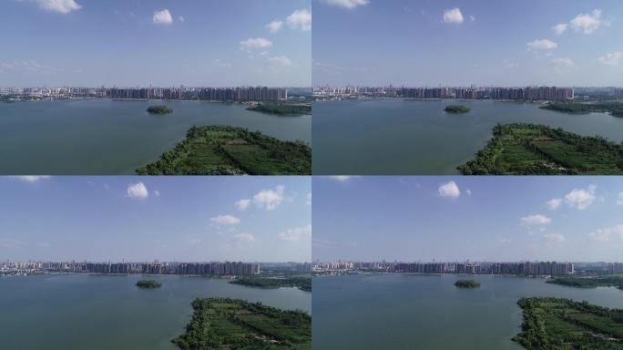 蓝天白云下湖边绿地边城市航拍全景