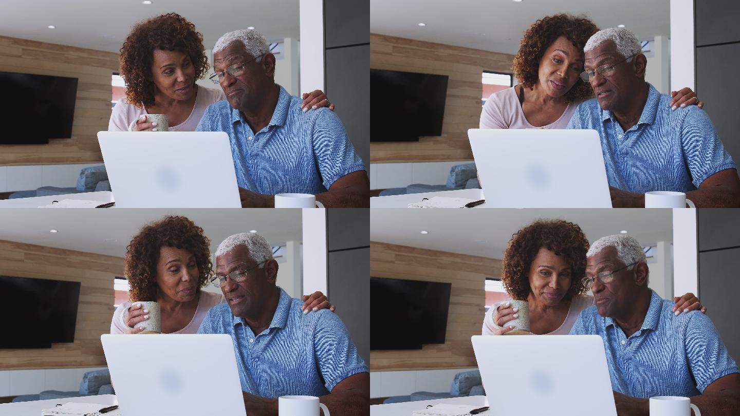 老年夫妇在家使用笔记本电脑查看财务状况