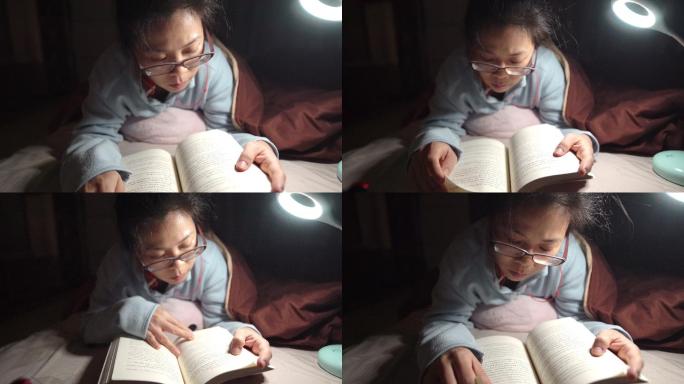 女生晚上在床上看书