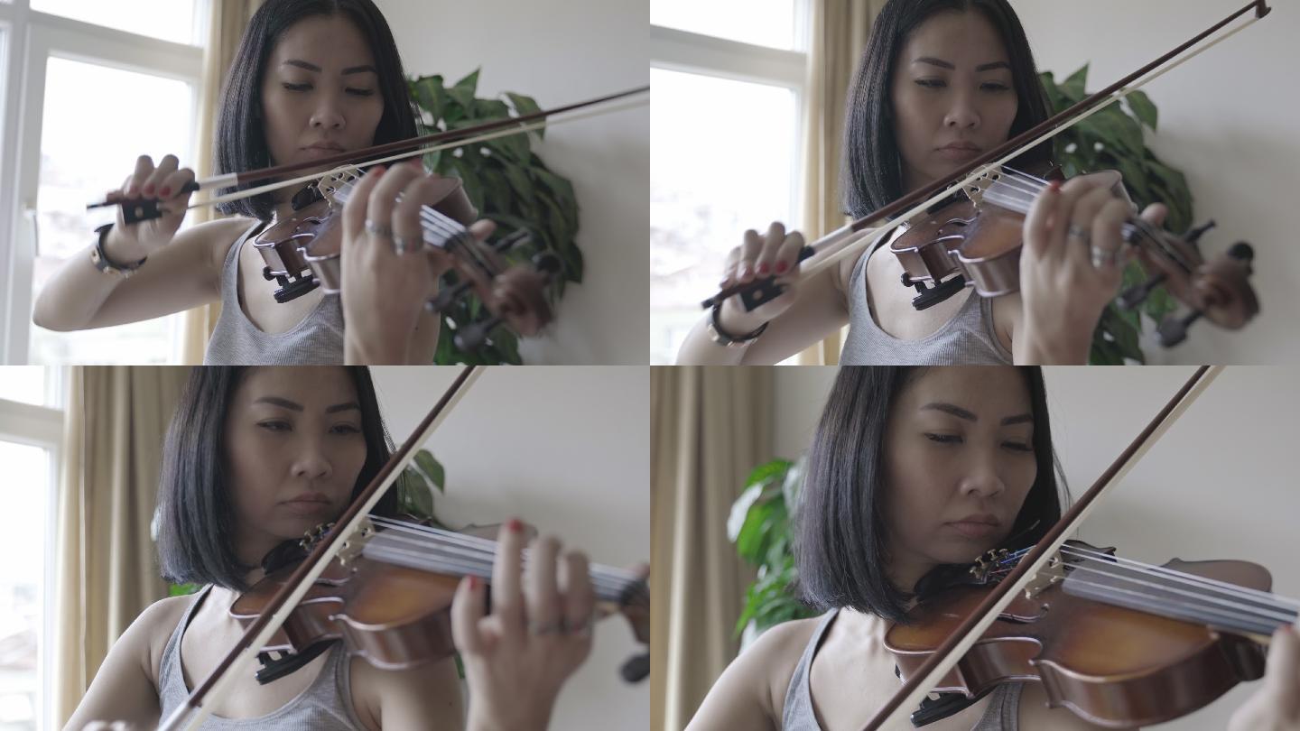 小提琴家亚洲女子在家拉小提琴
