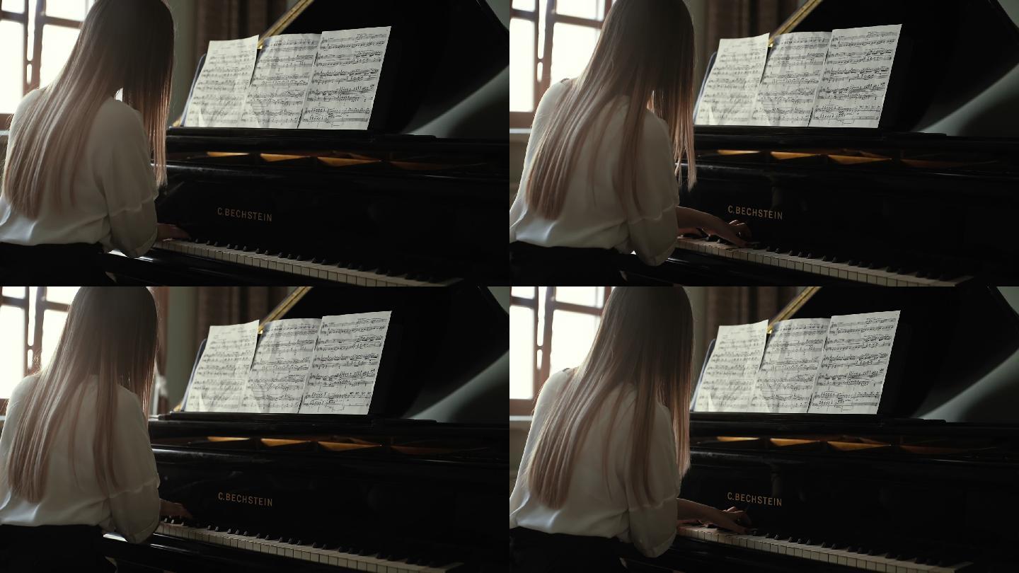 女钢琴家在钢琴上弹奏平静的古典音乐
