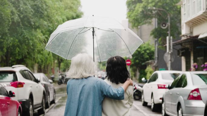 两位年长的妇女在雨天在城里散步