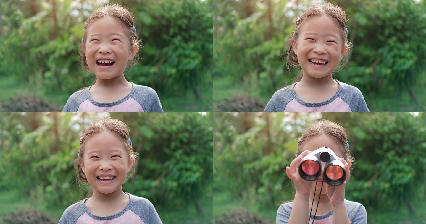 可爱快乐的小女孩用双筒望远镜