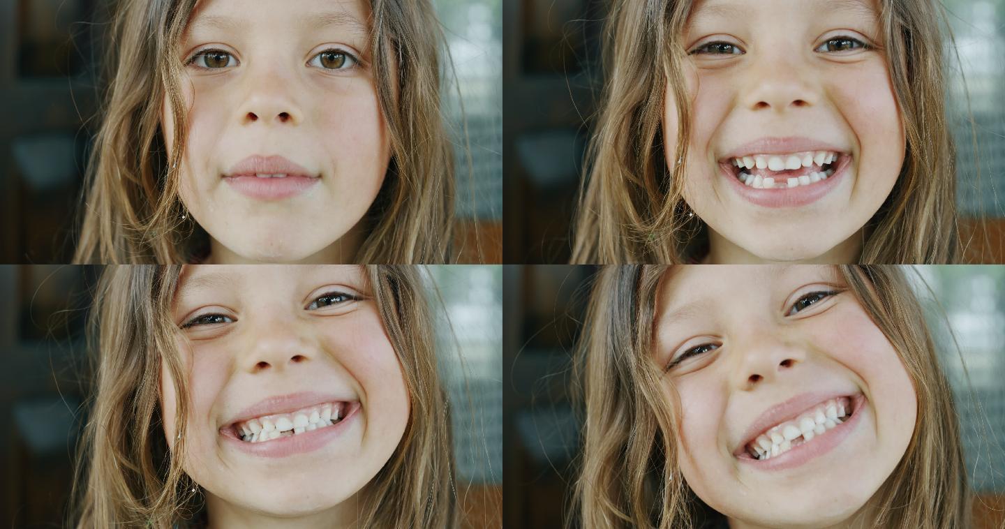 小女孩在屋外用腐烂的牙齿对着镜头微笑