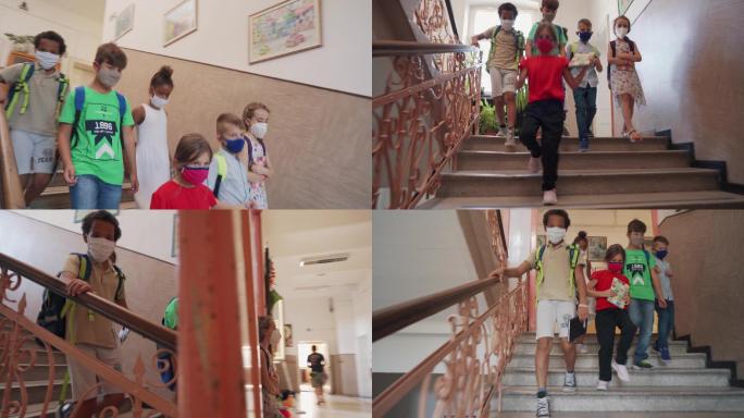 小学生正在学校里走下楼梯。