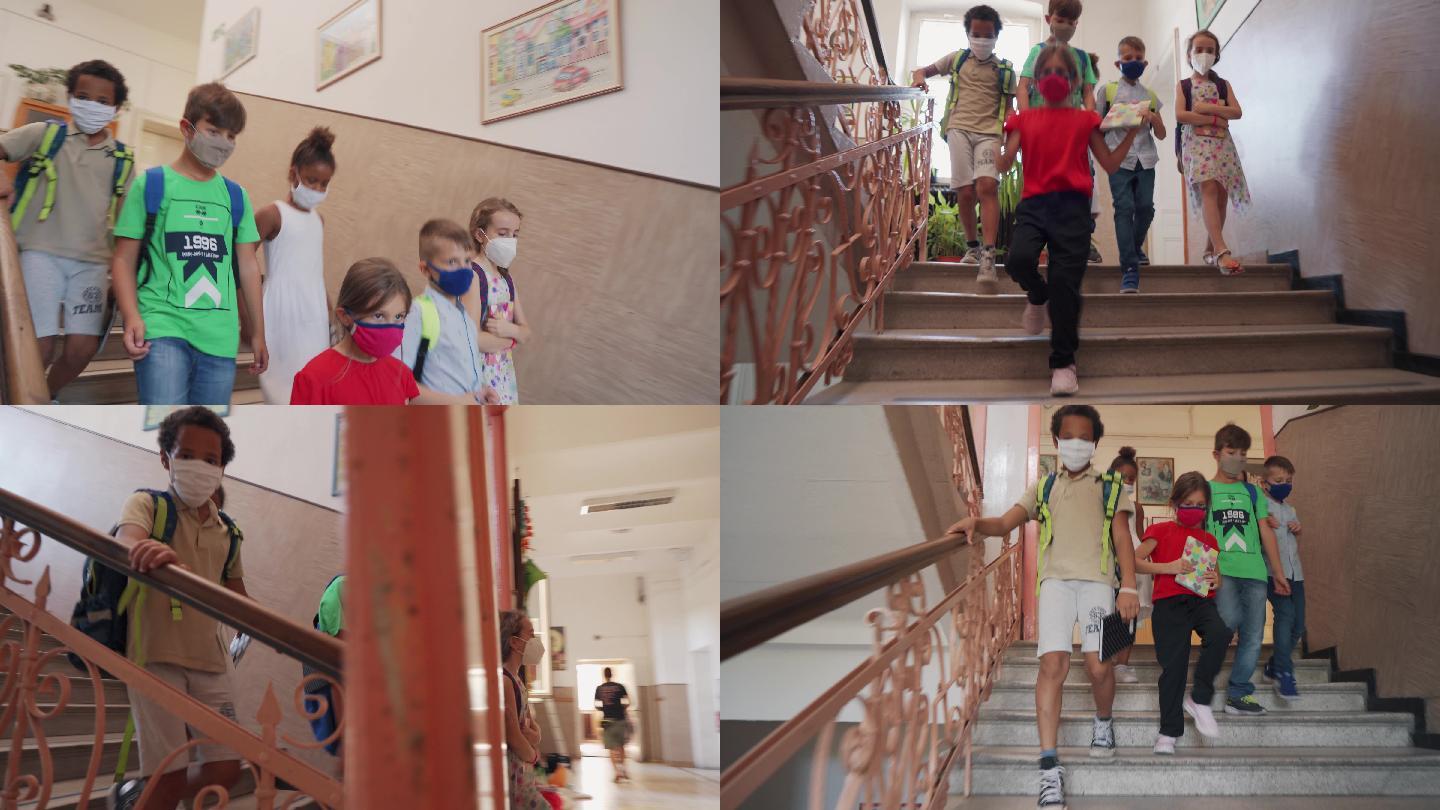 小学生正在学校里走下楼梯。