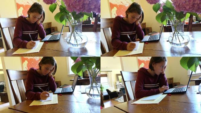 女孩在餐厅用笔记本电脑和纸做作业