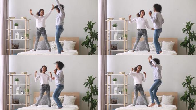 混血母亲和女儿在床上欣赏音乐跳舞