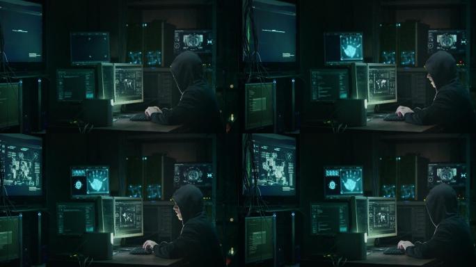 在黑暗的办公室里黑客正在操作电脑