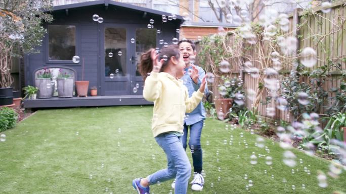 孩子们在花园里嬉笑追逐泡泡