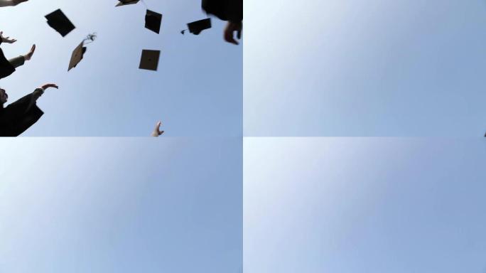 毕业生将毕业帽抛向空中