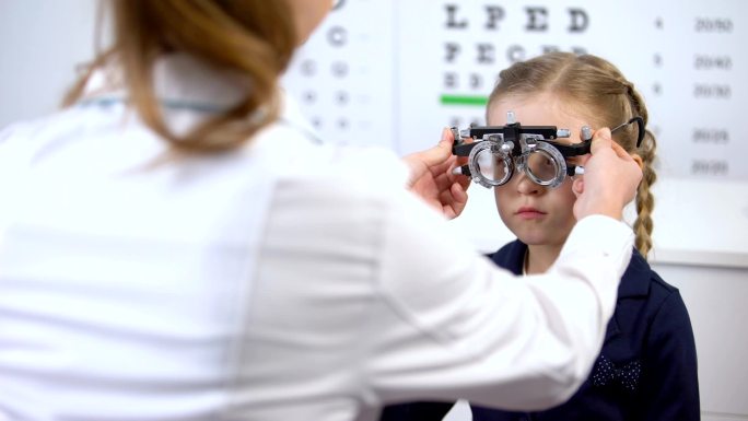 小女生到眼科医生那用荧光增强器测量视力