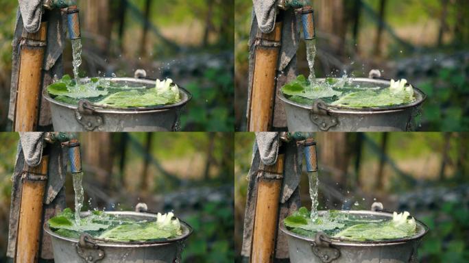农村生活，一个正在放水冲洗蔬菜的水龙头