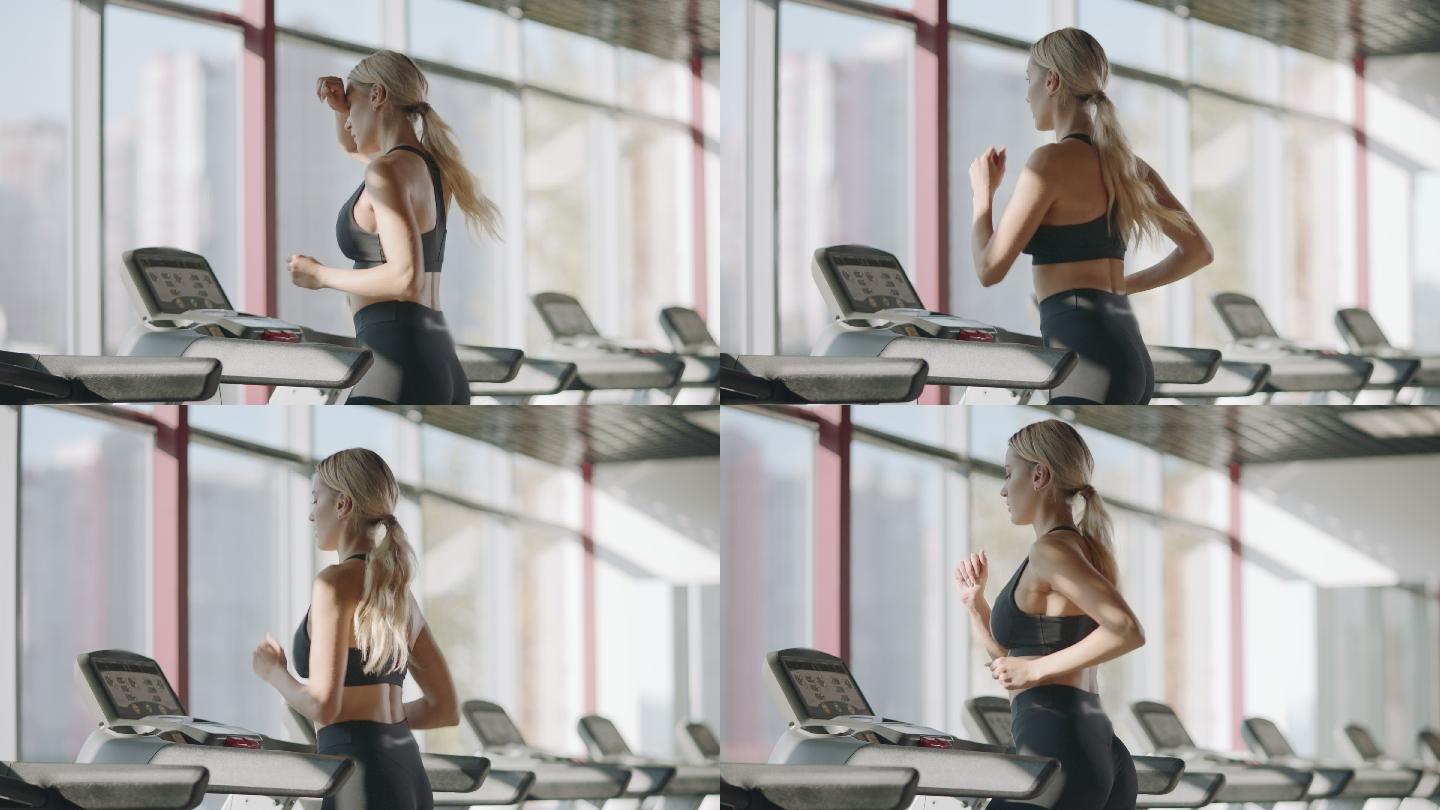 在健身房跑步机上锻炼的女性。