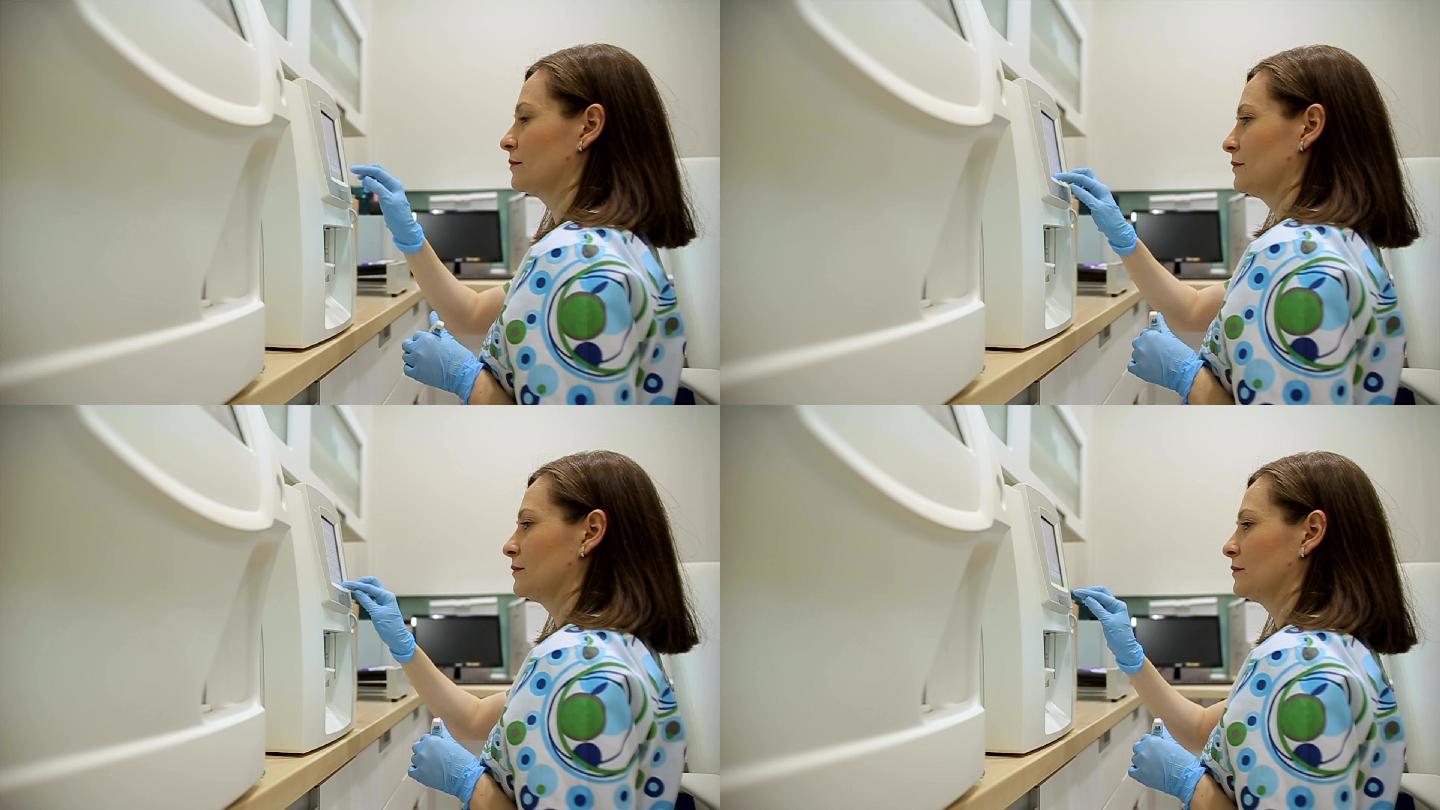 护士调整现代医疗设备进行血液检测与分析