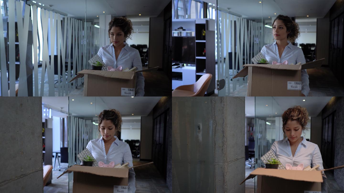 拿着盒子和办公用品的妇女感到不安——失业