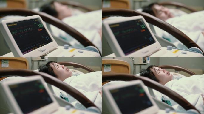 病床上的孕妇和正在测试的医疗设备