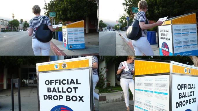 在官方投票箱邮寄缺席选票的妇女