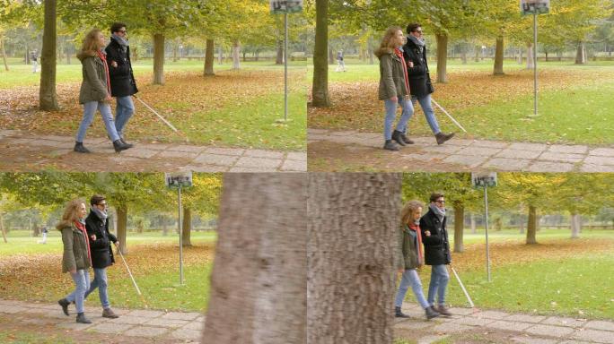 一个盲人和他的女朋友在公园散步