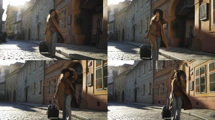 游客在欧洲小镇的市中心拉着手提箱