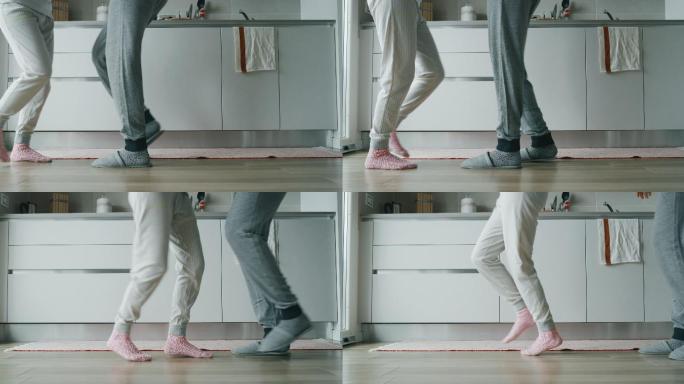 一对穿着睡衣的年轻夫妇在厨房跳舞