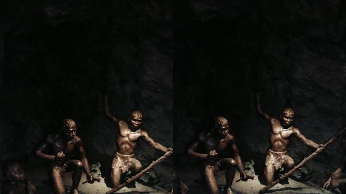 原始人祖先在山洞里烤火的雕像