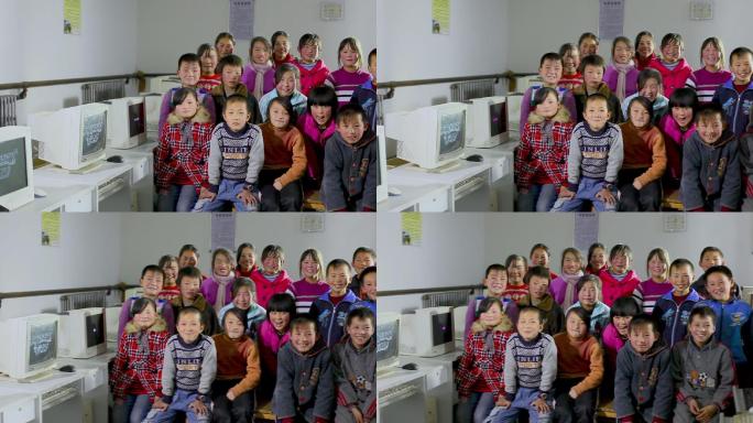 贫困地区的小学生在电脑教室合影微笑