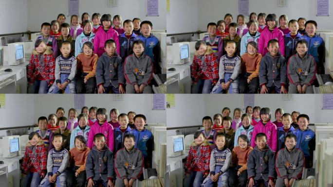 贫困地区的小学生在电脑教室合影微笑
