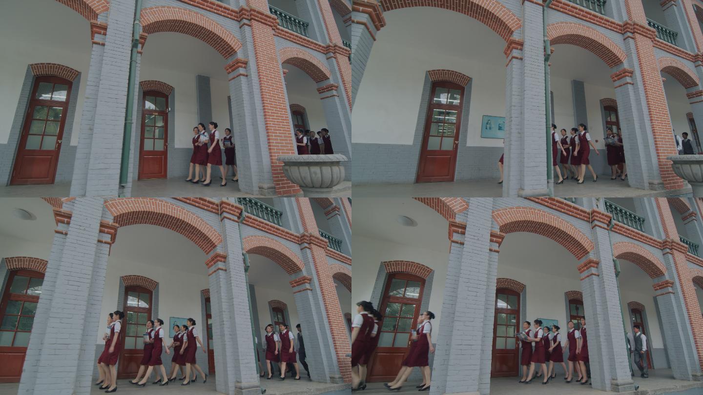 一群穿校服的女学生在校园里行走