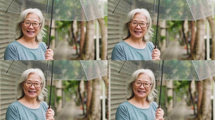 在城市雨天带着雨伞的老太太