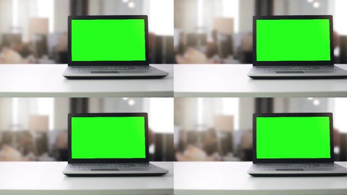 一台绿色空白屏幕的笔记本电脑
