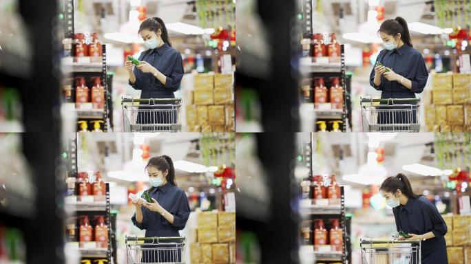 年轻女性戴着口罩在超市购物