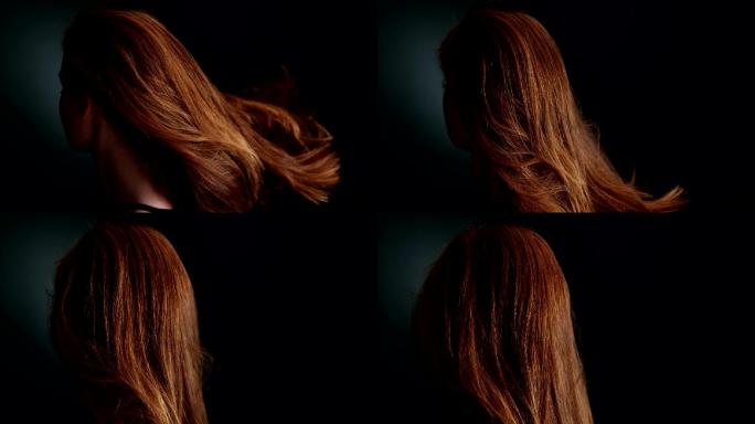 美丽的红发女孩甩着她的长发