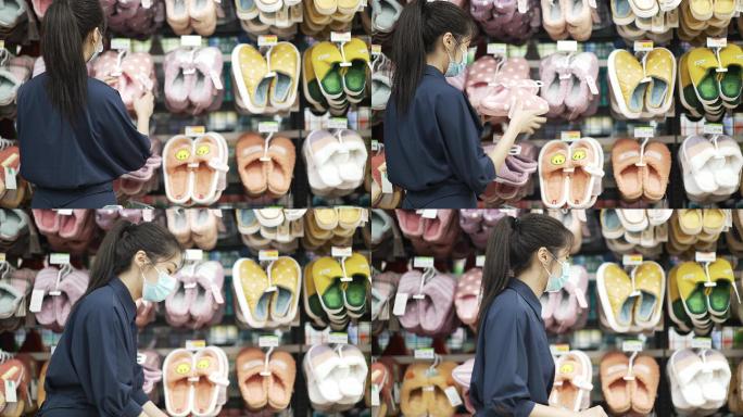 年轻中国女性在超市选购拖鞋