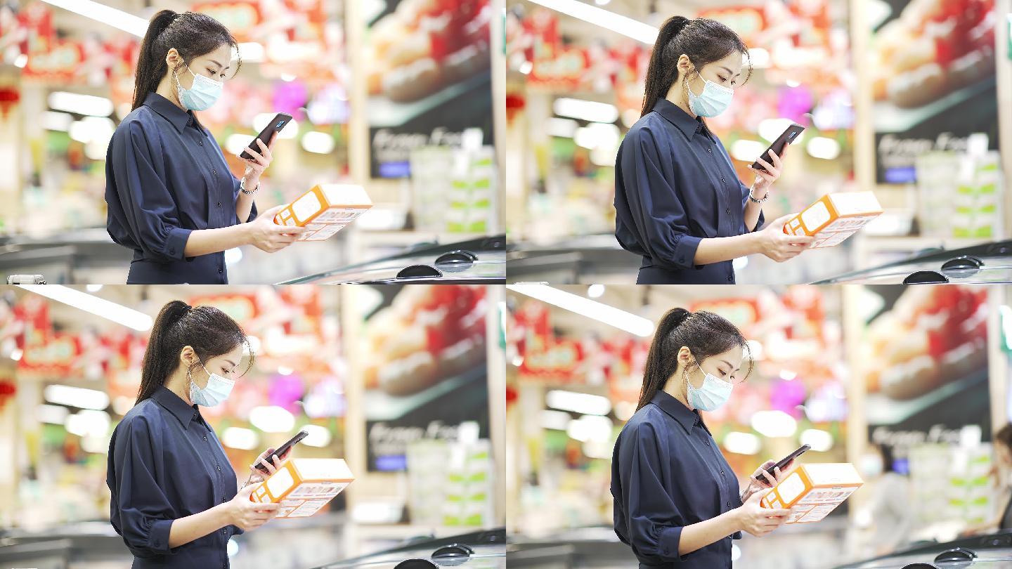 年轻中国女性在超市用手扫码查询信息