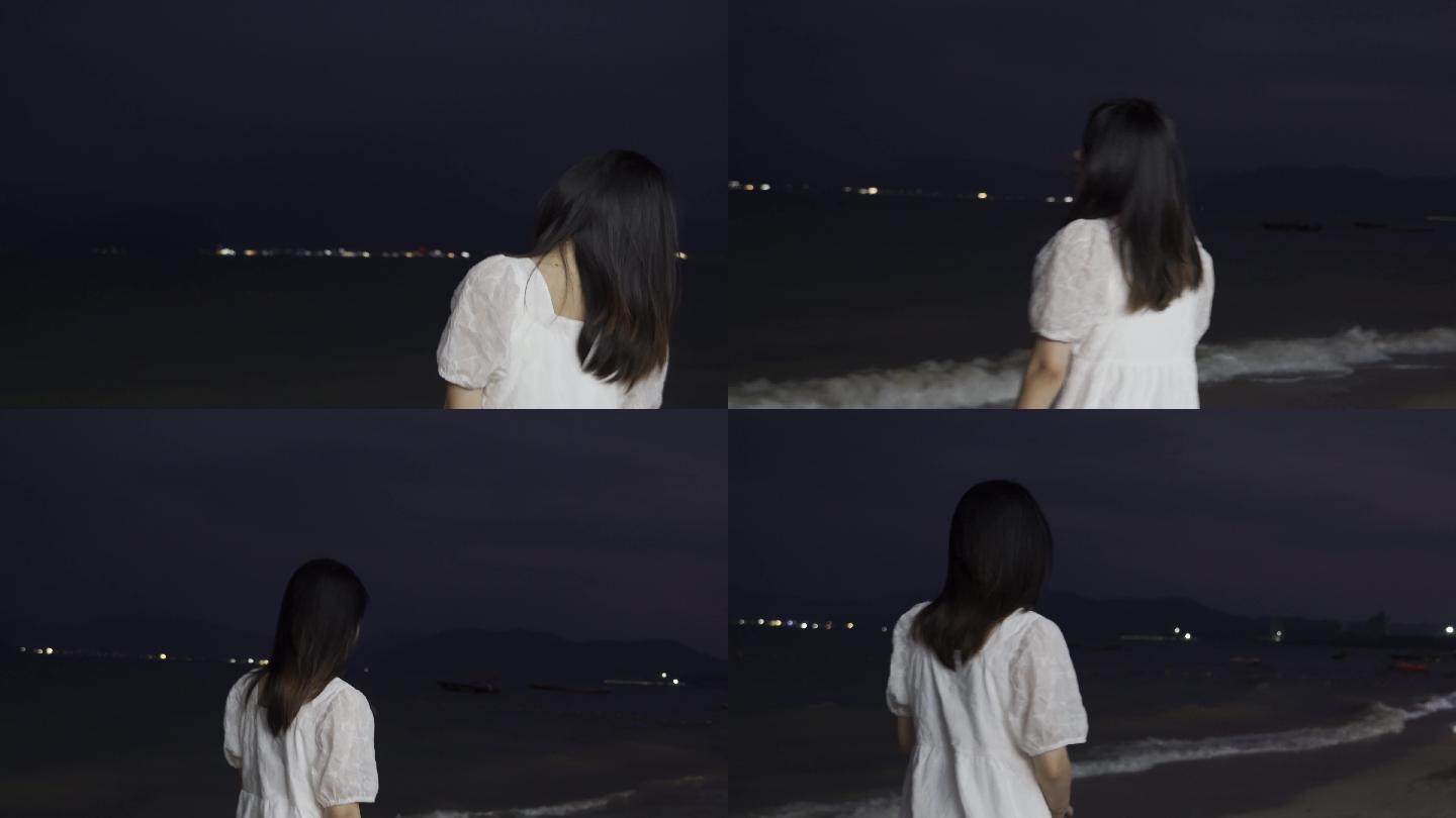 夜晚女孩在海边散步散心