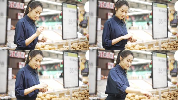 年轻中国女性农贸市场挑选核桃