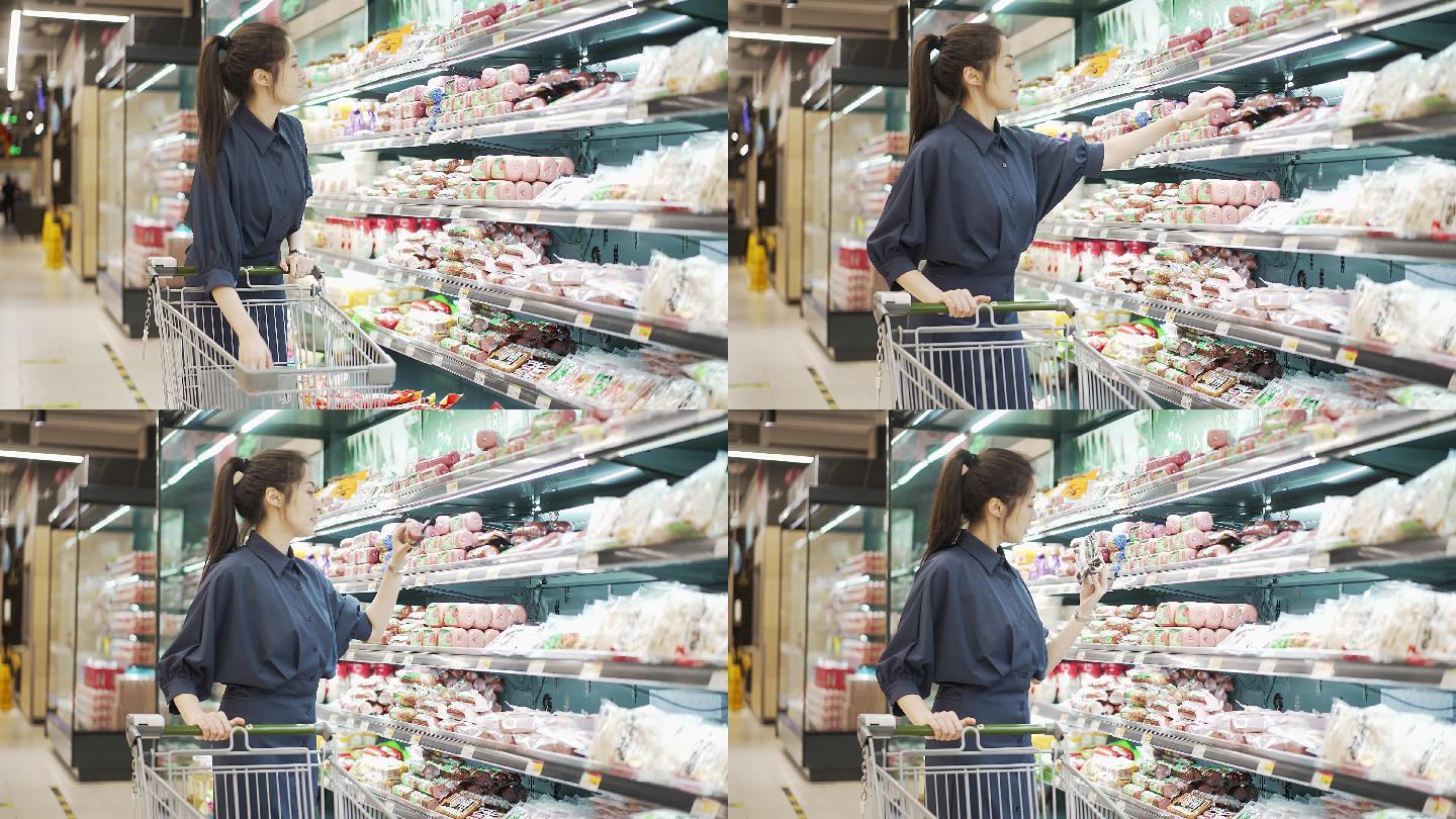 年轻中国女性推着小推车在超市购物