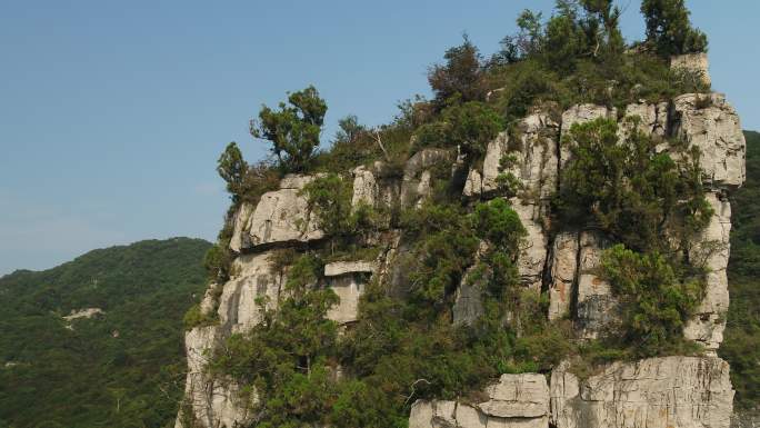 航拍阳光蓝天岩石孤峰峭壁松树