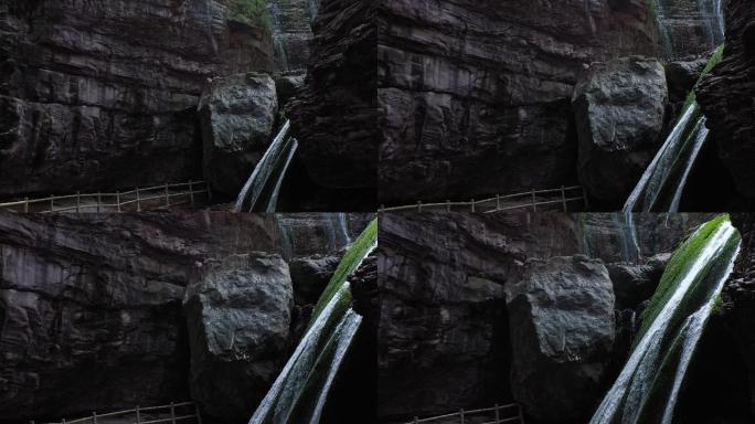 航拍高山峡谷红色岩石崖壁瀑布青苔